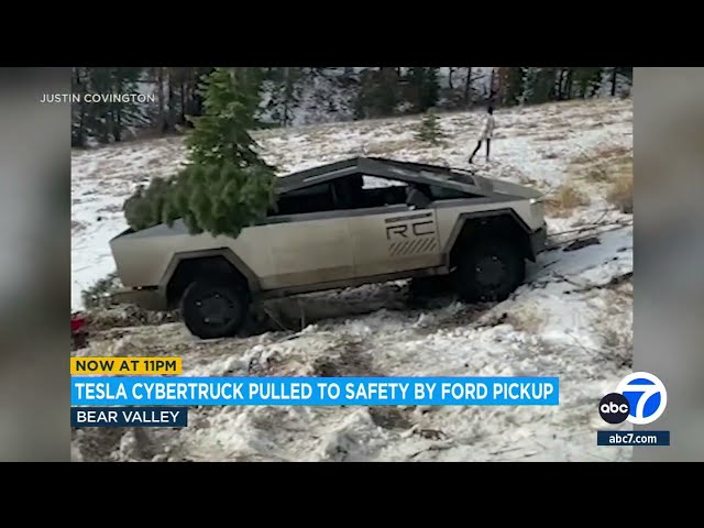 Tesla Cybertruck pulled to safety by Ford pickup after getting stuck in snowy embankment