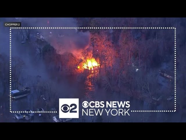 Firefighters struggle to get through floodwaters to battle blaze in Lincoln Park, N.J.