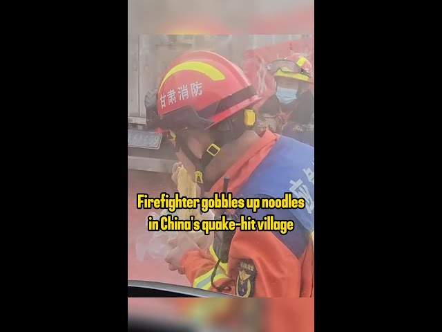 Firefighter gobbles up noodles in China's quake-hit village