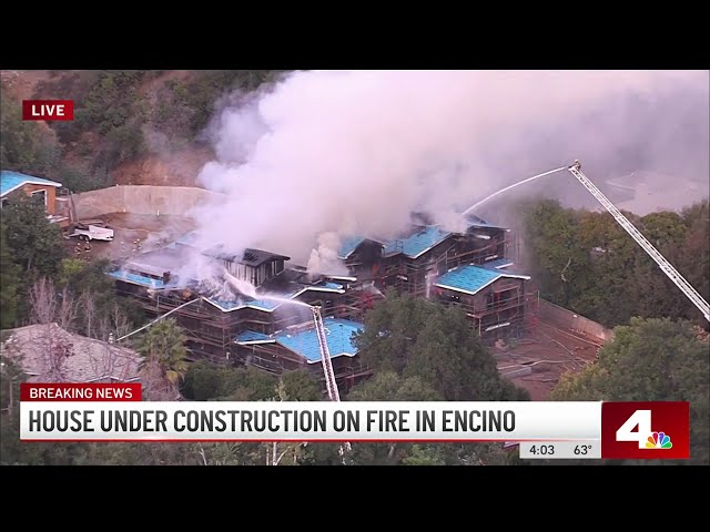 Crews battle large house fire in Encino