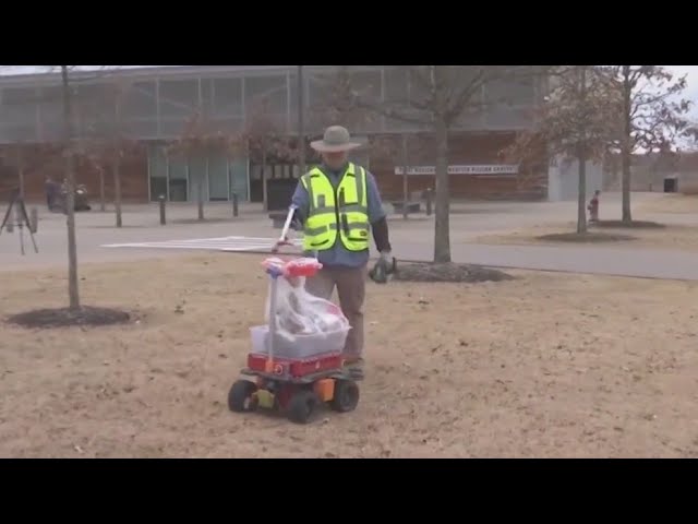 Man uses remote control garbage can to help pick up litter