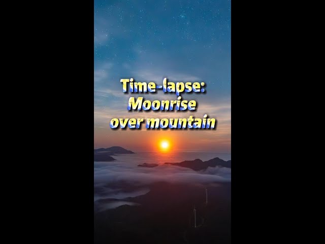 Time-lapse: full moon rising over mountain in S China