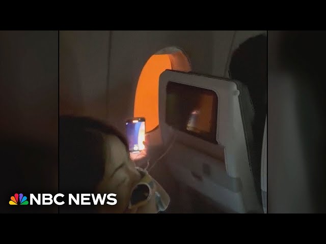 Video shows passengers stuck on burning plane in Japan