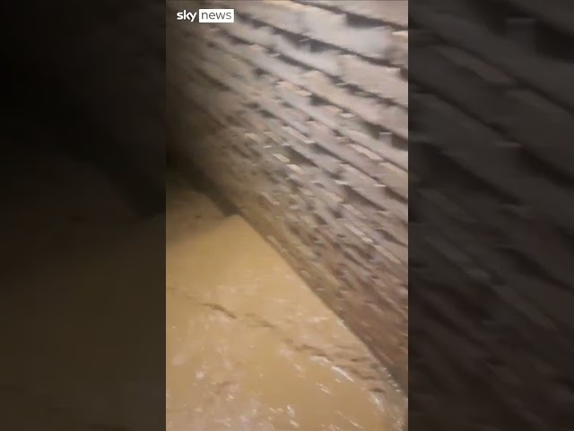 Floodwaters rage around home