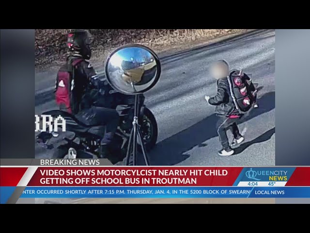 Video shows motorcyclist pass school bus, almost hit child