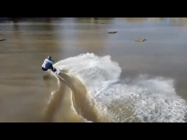 Drone footage captures man wakeboarding through floodwaters in UK