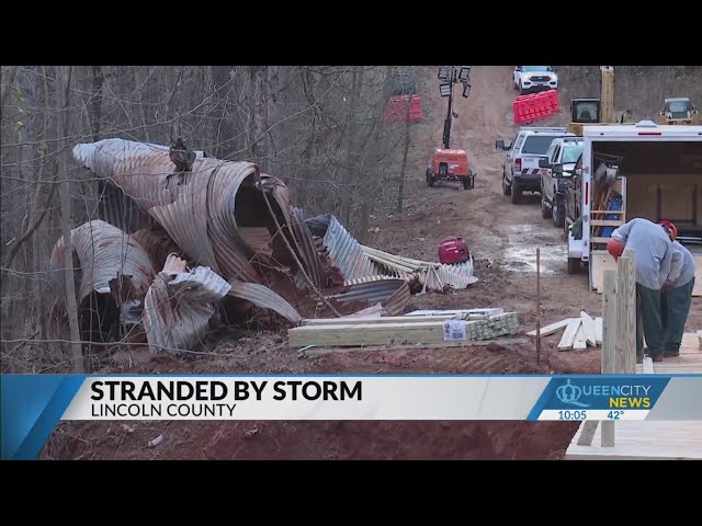 Families stranded by washed-out bridge, crews building makeshift