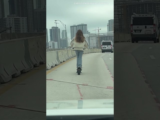 Woman rides scooter on Miami highway