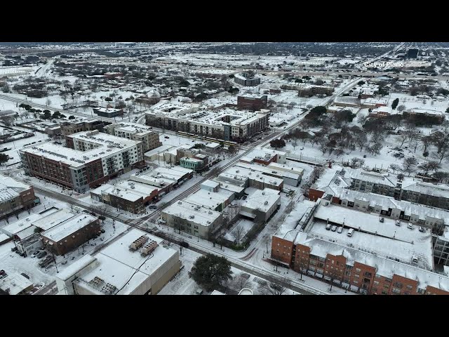 Plano snow: Drone flies over snow-covered city