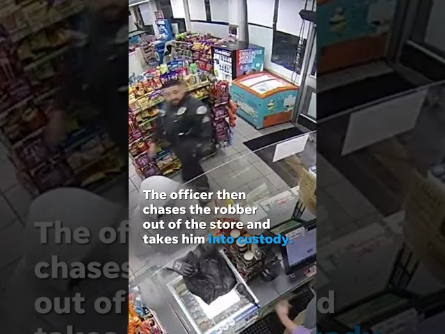 Police officer unknowingly interrupts a robbery in progress #Shorts