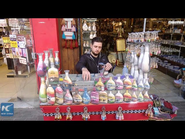 Sand bottle artist in Jordan expresses hope for peace in Gaza