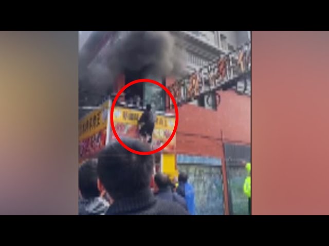 People jump from windows to escape building fire in China