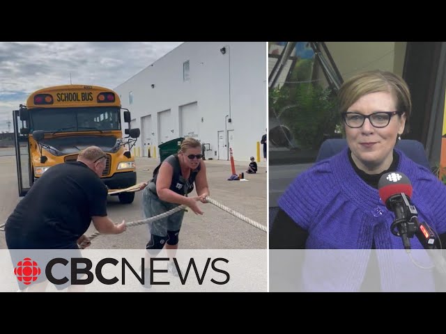 This Strongman competitor is a woman who can move a school bus