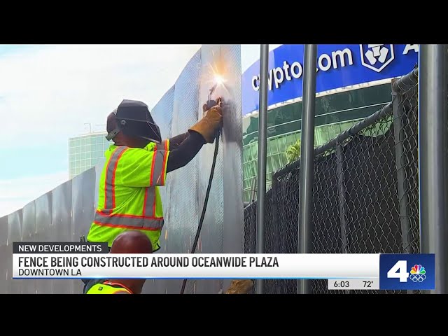 Crews begin building fence around graffiti-covered towers in DTLA