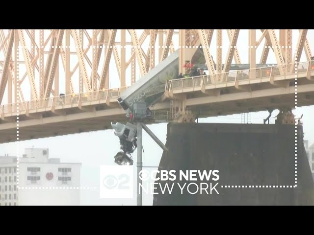 Rescuers pull driver from semi-truck dangling off bridge in Kentucky