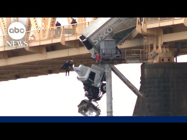 Crew rescued semi truck driver dangling from bridge