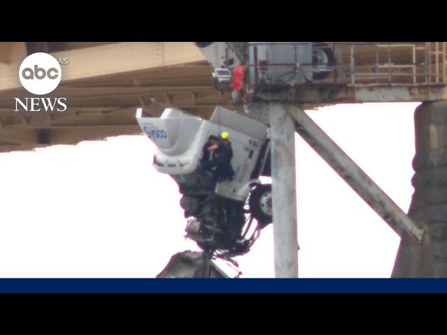 Moment a firefighter performs harrowing rescue from a truck hanging over Ohio river bridge