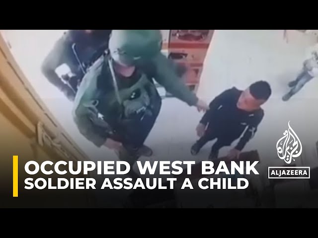 Israeli soldiers assault a Palestinian child in a shop in Hebron