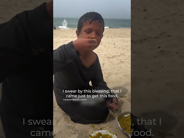 Hungry Palestinian boy eats food from foreign aid drops