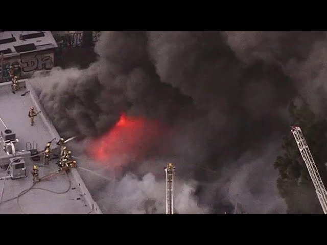 Fire crews battle fire at Sportswear store fire in downtown LA