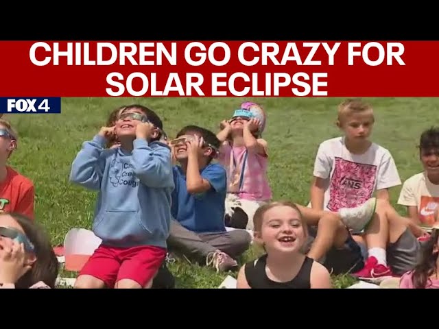 ⁣Families enjoy watching solar eclipse together
