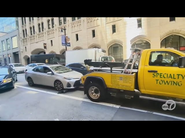 ⁣Tow-truck driver tries to hook moving car in San Francisco