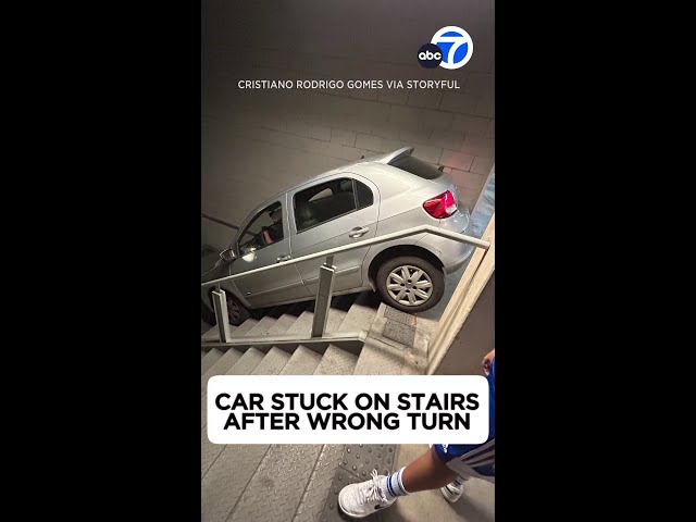 ⁣Car stuck on stairs in Brazilian parking garage after wrong turn