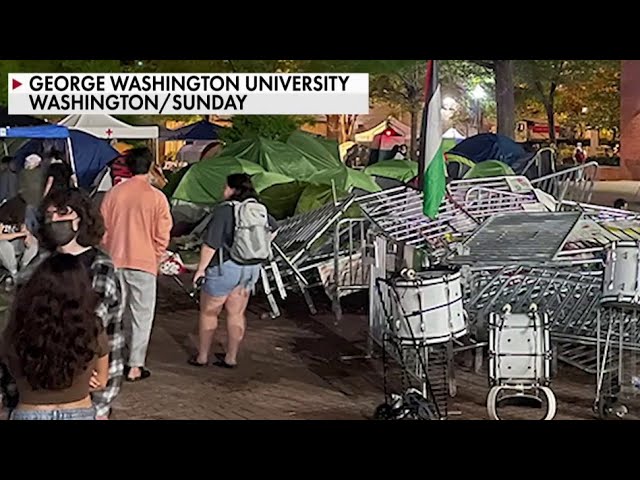 ⁣Protesters at George Washington University tear down police barriers