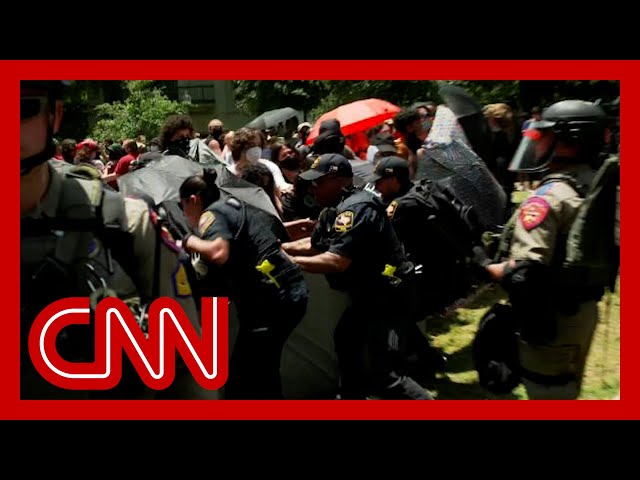 ⁣Watch moment police tear down protesters' barrier at University of Texas at Austin