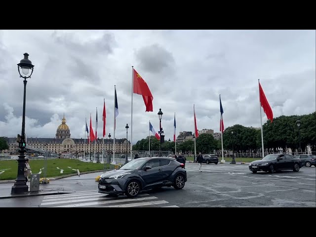 ⁣Chinese national flags fly over Paris' streets to greet President Xi