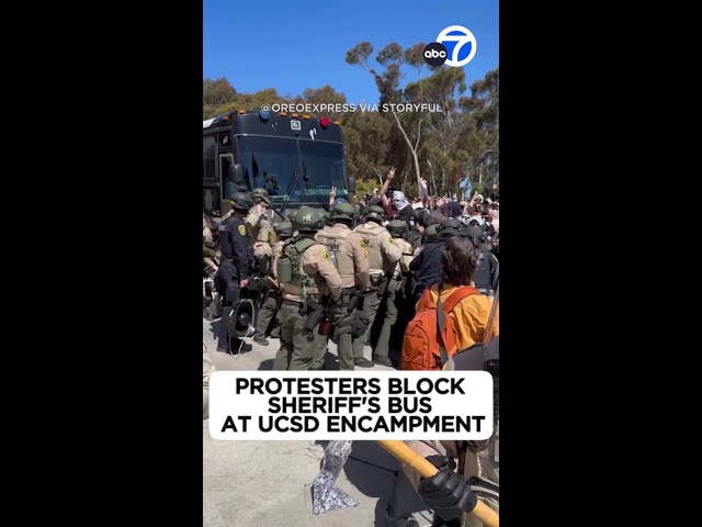 ⁣Protesters block sheriff's bus at UCSD encampment
