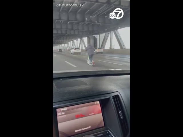 ⁣Man rides electric Lime scooter across lower deck of Bay Bridge