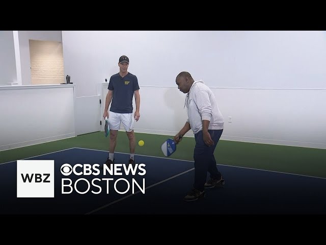 ⁣WBZ reporter interviews pickleball player during game on live TV
