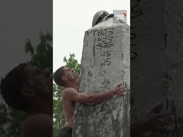 ⁣US Naval Academy cadets climb up greased monument in quirky annual tradition
