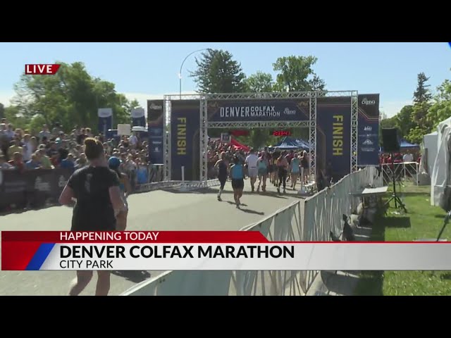 ⁣Runners cross the finish line at the Denver Colfax Marathon
