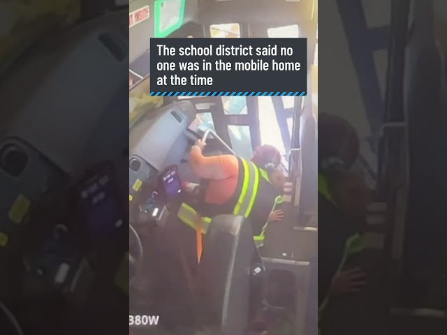 ⁣Video shows school bus crash into mobile home