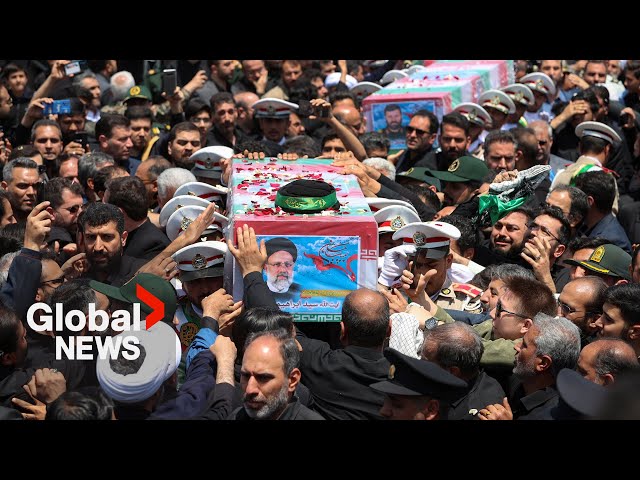 ⁣Thousands fill streets of Iran as President Raisi laid to rest