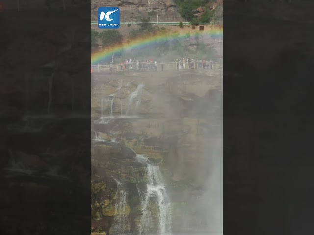 ⁣Hukou Waterfall meets "rainbow bridge" in NW China