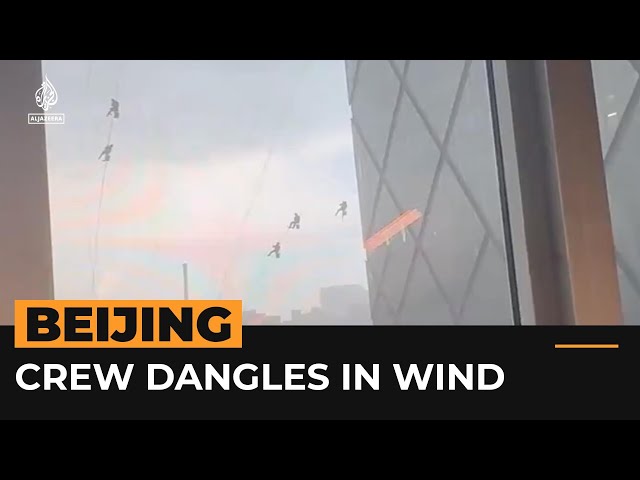 ⁣High winds leave crew dangling from Beijing skyscraper | #AJshorts