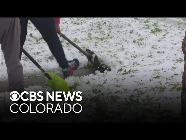 ⁣Some Denver metro area residents shovel hail after severe storms cause damage