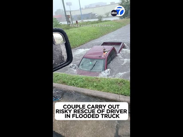 ⁣Risky rescue! Couple helps Houston driver stuck in flooded truck