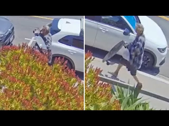 ⁣Video shows man smashing SUV's back window with skateboard in Long Beach