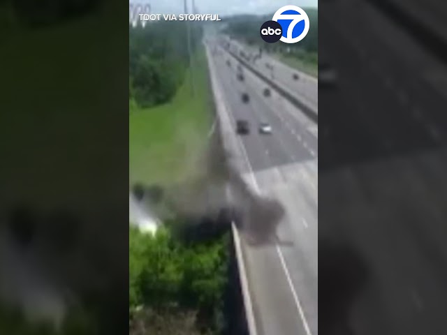 ⁣Semi-truck skids off freeway, tumbles into creek