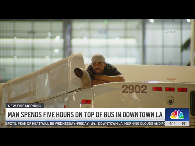 ⁣Man climbs on top of bus and stays there for 5 hours in downtown LA