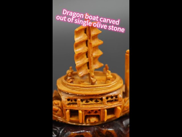 ⁣Dragon boat carved out of single olive stone