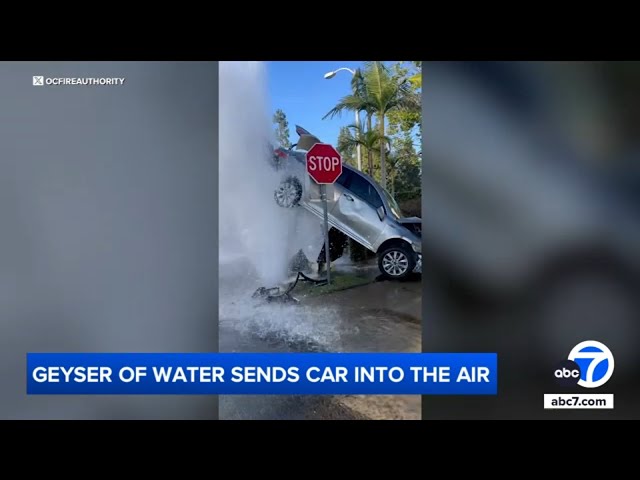 ⁣Car suspended in air by water gushing from fire hydrant after crash in Lake Forest