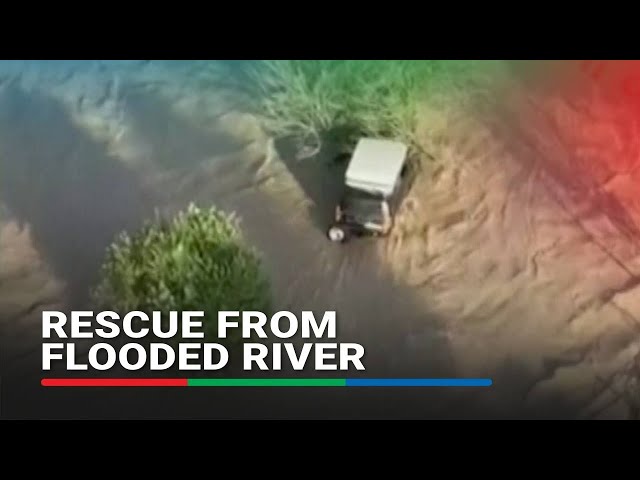 ⁣Family rescued from car stuck in flooded river