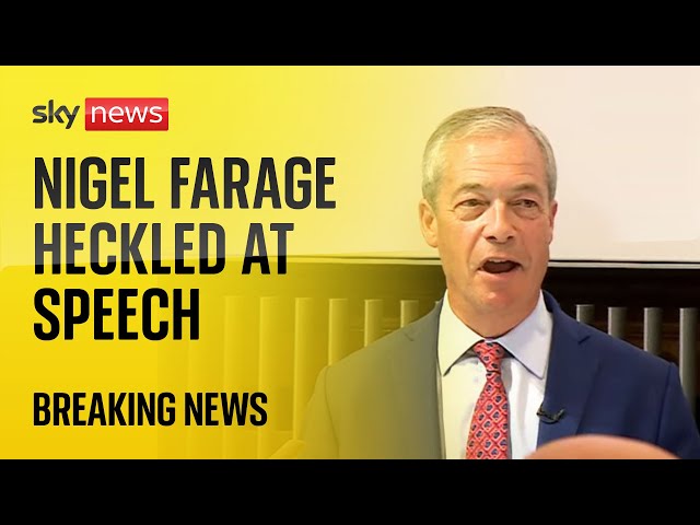 ⁣'You're a racist': Seven protesters interrupt Farage speech