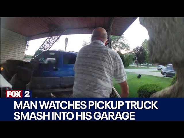 ⁣Man watches as truck collides with his garage in Sterling Heights