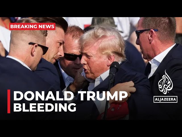 Former President Donald Trump bleeding after what sounded like gunshots